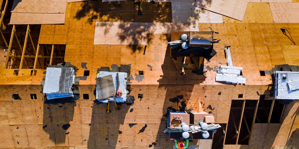 Construction worker on a renovation roof the house installed new shingles Construction worker on a renovation roof the house installed new shingles