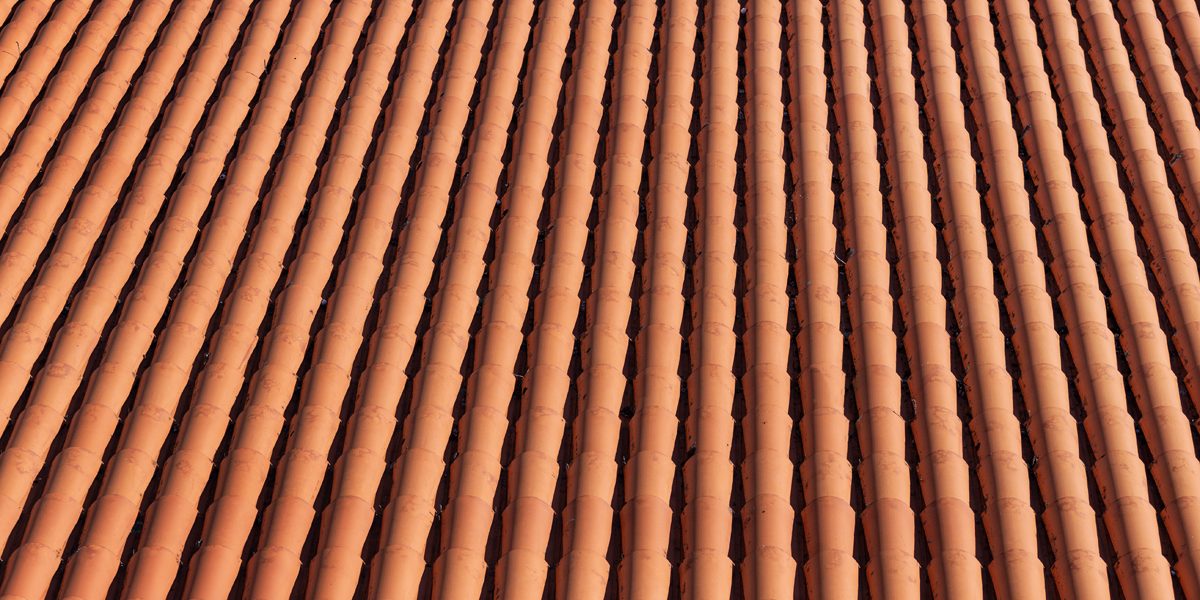 Traditional red clay roof tiles background. Top view